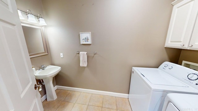 3805 Irby Dr, Conway, AR 72034 - laundry area featuring washer and dryer, cabinet space, baseboards, and light tile patterned floors