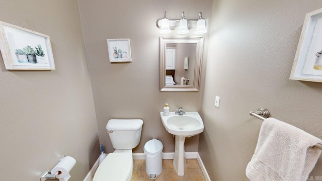 3805 Irby Dr, Conway, AR 72034 - half bathroom with toilet, baseboards, and a sink