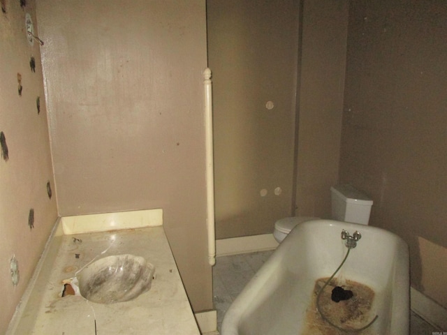 2111 S Arch St, Little Rock, AR 72206 - full bathroom with baseboards, a bath, vanity, and toilet