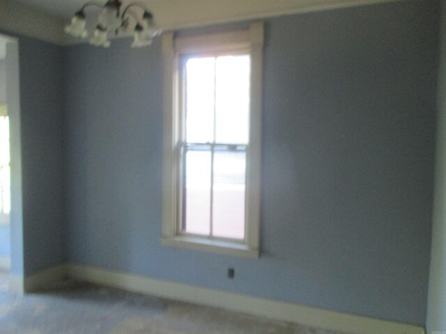 2111 S Arch St, Little Rock, AR 72206 - spare room with baseboards and a chandelier