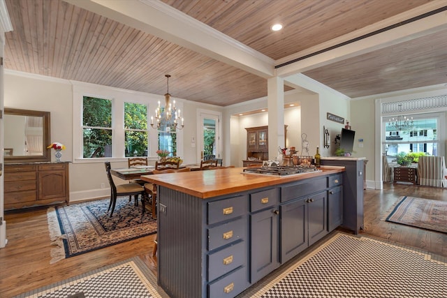 kitchen featuring butcher block countertops, wood ceiling, a chandelier, healthy amount of natural light, and light wood-style flooring