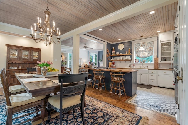 dining space featuring ornamental molding, light wood-style flooring, recessed lighting, wood ceiling, and a chandelier