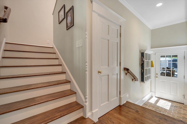 foyer with ornamental molding, baseboards, recessed lighting, stairway, and wood finished floors