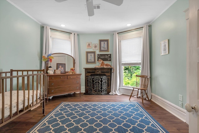 bedroom with wood finished floors, crown molding, baseboards, ceiling fan, and recessed lighting