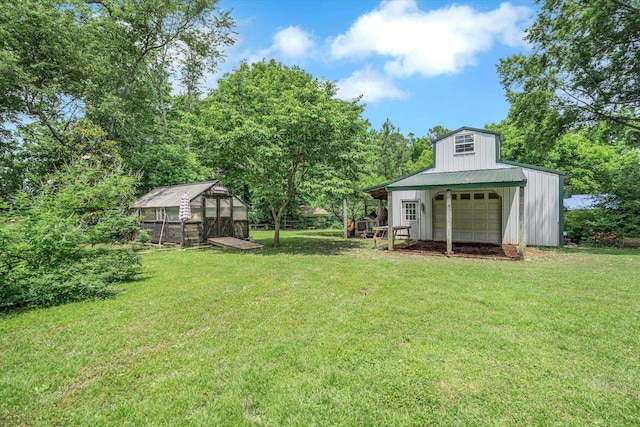 view of green lawn featuring a garage, an outdoor structure, an exterior structure, and driveway