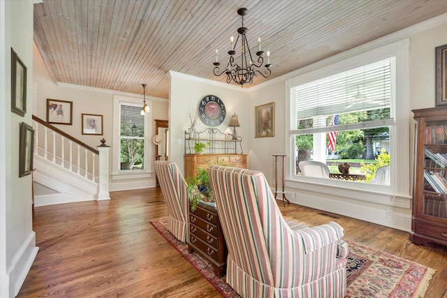 sitting room with ornamental molding, a chandelier, plenty of natural light, stairway, and wood finished floors