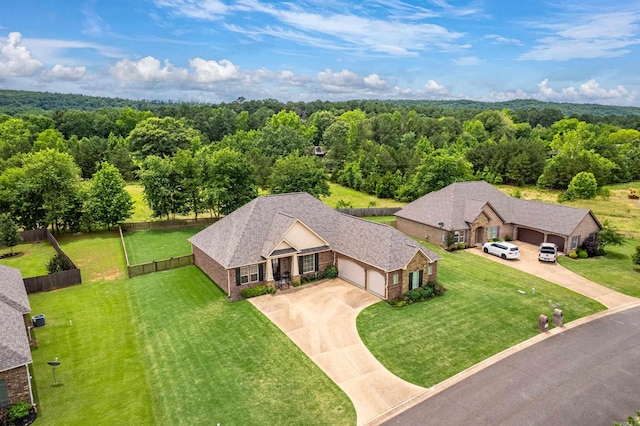 aerial view of property and surrounding area with a forest