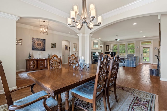 dining area featuring a chandelier, ceiling fan, arched walkways, wood-type flooring, and recessed lighting