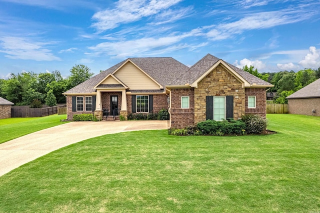 craftsman house with brick siding, roof with shingles, and stone siding