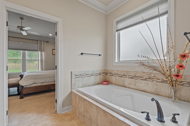 ensuite bathroom with ornamental molding, a garden tub, a ceiling fan, tile patterned flooring, and baseboards