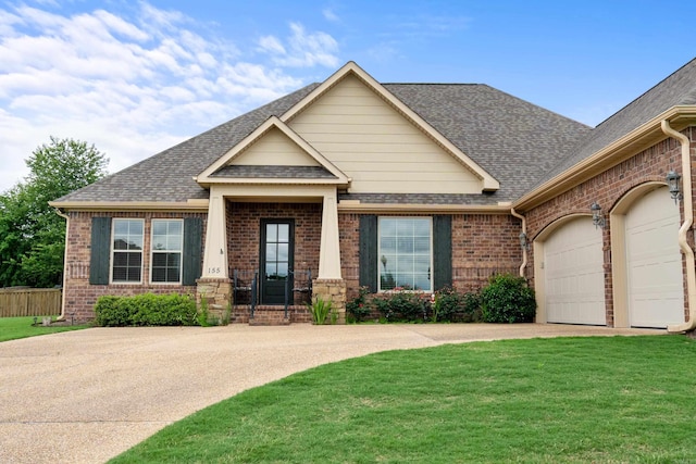 view of front of house with brick siding, roof with shingles, driveway, and a garage