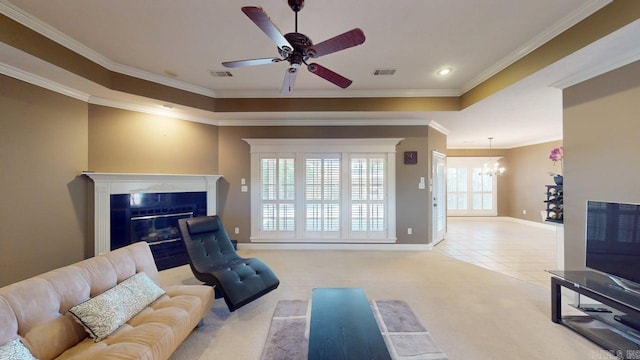 4335 Gazebo Dr, Conway, AR 72034 - living room with a chandelier, a glass covered fireplace, ornamental molding, a raised ceiling, and a ceiling fan