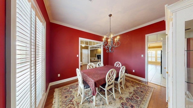 4335 Gazebo Dr, Conway, AR 72034 - dining area with a chandelier, wood finished floors, baseboards, and crown molding