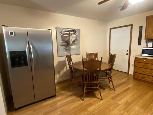 47 Eagle Ln, Mount Ida, AR 71957 - dining room featuring light wood-style flooring, ceiling fan, electric panel, and baseboards