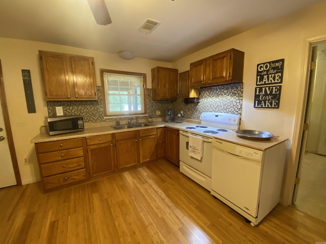 47 Eagle Ln, Mount Ida, AR 71957 - kitchen featuring white appliances, a sink, light wood-style flooring, and light countertops