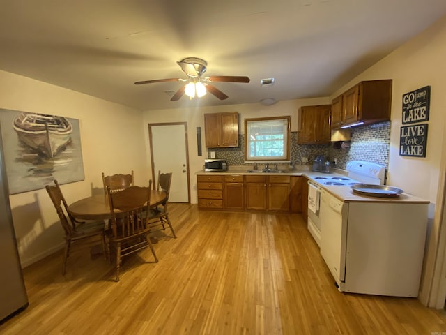 47 Eagle Ln, Mount Ida, AR 71957 - kitchen featuring stainless steel microwave, light wood-type flooring, white electric range oven, tasteful backsplash, and light countertops