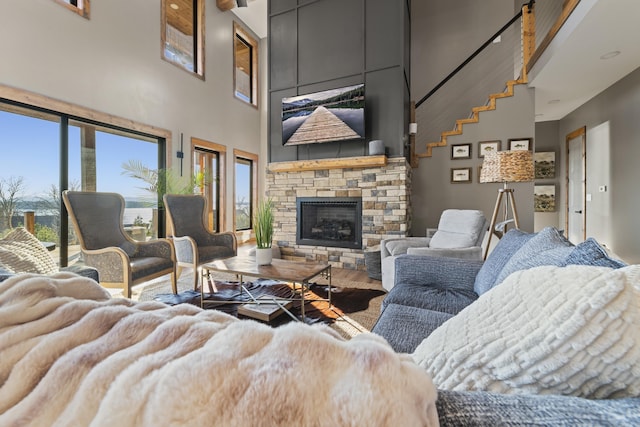 2634 Tannenbaum, Drasco, AR 72530 - living area featuring a high ceiling, wood finished floors, and a stone fireplace