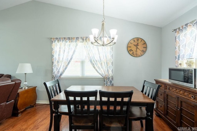 1244 N Scenic Dr, Heber Springs, AR 72543 - dining room featuring lofted ceiling, a chandelier, dark wood-style floors, and baseboards