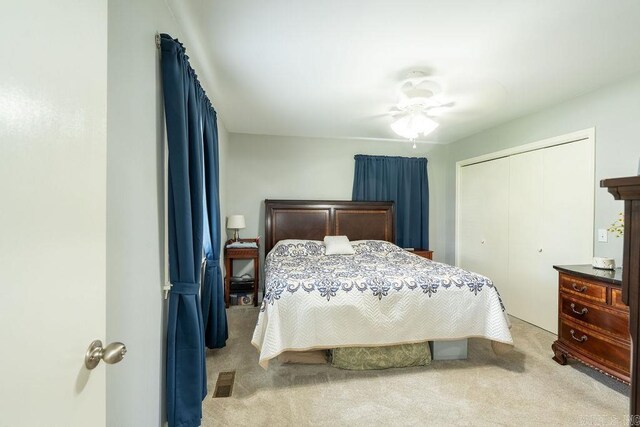 1244 N Scenic Dr, Heber Springs, AR 72543 - bedroom with light colored carpet, a closet, and ceiling fan