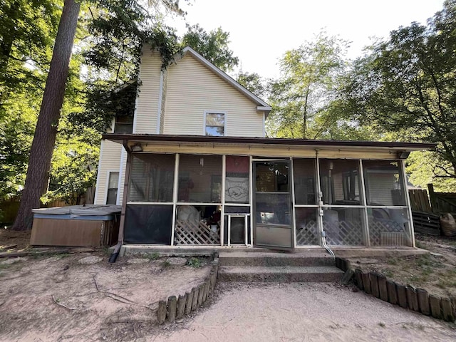 view of front of property featuring a hot tub and a sunroom