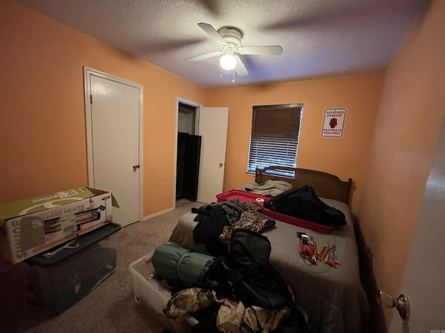 bedroom with carpet, a textured ceiling, and ceiling fan