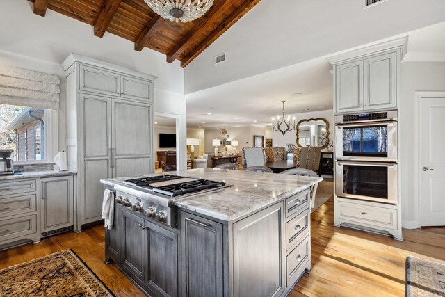 13200 Bart Moreland Dr, Roland, AR 72135 - kitchen featuring stainless steel appliances, a chandelier, light stone counters, wood ceiling, and light wood-style flooring