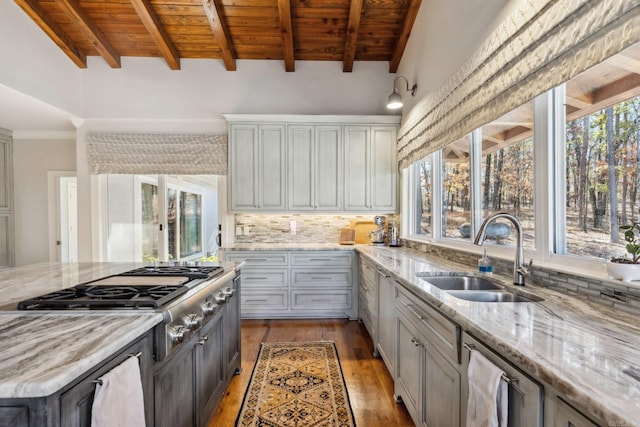 13200 Bart Moreland Dr, Roland, AR 72135 - kitchen featuring a sink, stainless steel gas cooktop, wooden ceiling with exposed beams, light wood-style flooring, and backsplash