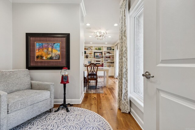 13200 Bart Moreland Dr, Roland, AR 72135 - living area featuring light wood-type flooring, a chandelier, recessed lighting, baseboards, and built in shelves
