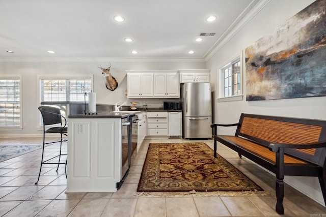 13200 Bart Moreland Dr, Roland, AR 72135 - kitchen with appliances with stainless steel finishes, ornamental molding, dark countertops, a peninsula, and a kitchen bar