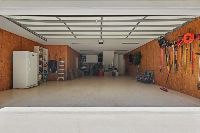 13200 Bart Moreland Dr, Roland, AR 72135 - garage featuring freestanding refrigerator and wooden walls