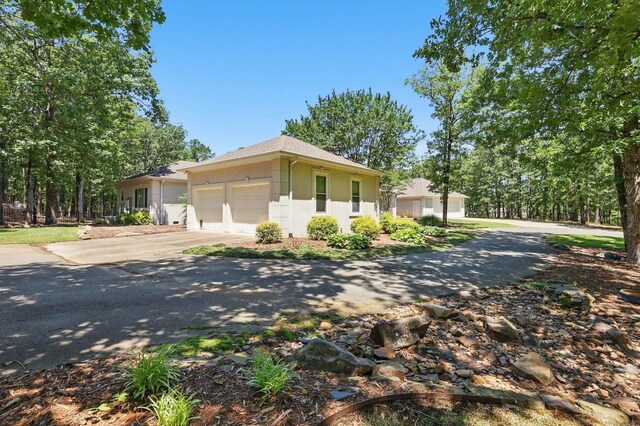 13200 Bart Moreland Dr, Roland, AR 72135 - ranch-style house featuring concrete driveway, stucco siding, and an attached garage