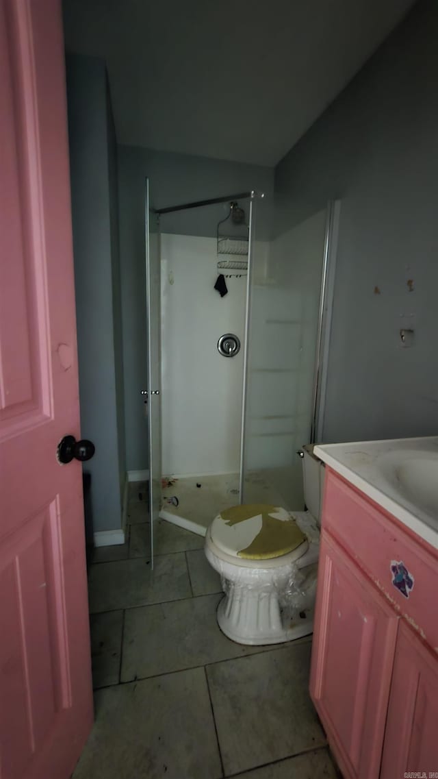 302 SW Broad St, Hoxie, AR 72433 - bathroom featuring a stall shower, vanity, toilet, and tile patterned flooring