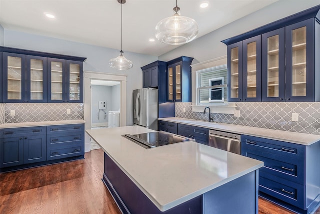 1908 S Gaines St, Little Rock, AR 72206 - kitchen with appliances with stainless steel finishes, blue cabinets, glass insert cabinets, a kitchen island, and recessed lighting