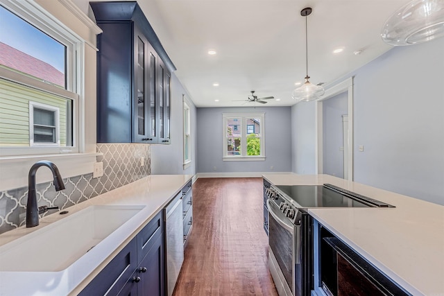 1908 S Gaines St, Little Rock, AR 72206 - kitchen with a sink, blue cabinets, appliances with stainless steel finishes, light countertops, and recessed lighting