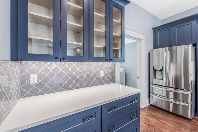 1908 S Gaines St, Little Rock, AR 72206 - kitchen with stainless steel fridge with ice dispenser, blue cabinets, light countertops, and glass insert cabinets