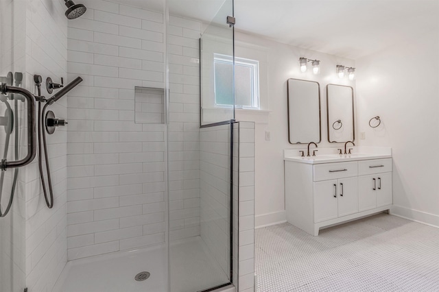 1908 S Gaines St, Little Rock, AR 72206 - full bath featuring a shower stall, double vanity, baseboards, and tile patterned flooring