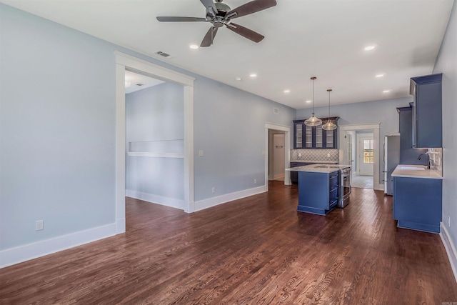 1908 S Gaines St, Little Rock, AR 72206 - kitchen with freestanding refrigerator, blue cabinetry, light countertops, a ceiling fan, and a sink