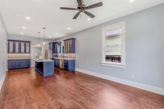 1908 S Gaines St, Little Rock, AR 72206 - kitchen with appliances with stainless steel finishes, a kitchen island, light countertops, tasteful backsplash, and a sink