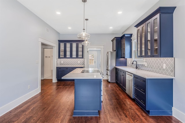 1908 S Gaines St, Little Rock, AR 72206 - kitchen featuring appliances with stainless steel finishes, blue cabinetry, backsplash, light countertops, and glass insert cabinets
