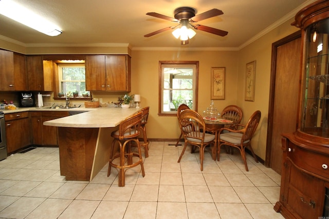 2102 N 22nd St, Paragould, AR 72450 - kitchen with a peninsula, a sink, light countertops, ceiling fan, and a kitchen bar