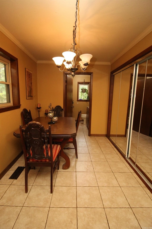 2102 N 22nd St, Paragould, AR 72450 - dining space with a chandelier, ornamental molding, and light tile patterned floors