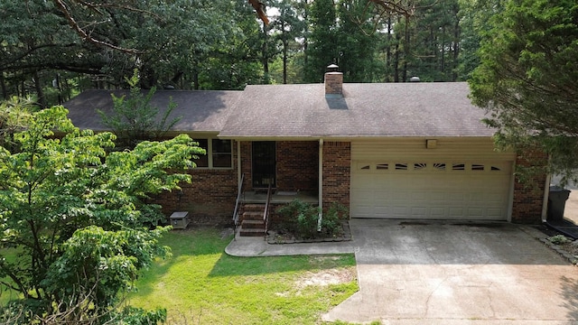 2102 N 22nd St, Paragould, AR 72450 - ranch-style house with an attached garage, concrete driveway, brick siding, a front lawn, and a shingled roof