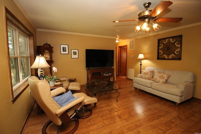 2102 N 22nd St, Paragould, AR 72450 - living area featuring hardwood / wood-style flooring, crown molding, a ceiling fan, and baseboards