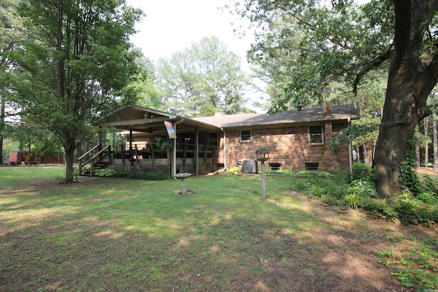 2102 N 22nd St, Paragould, AR 72450 - rear view of house featuring a lawn, brick siding, central AC, and a ceiling fan
