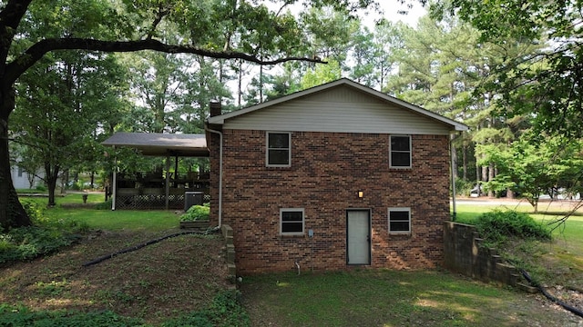 2102 N 22nd St, Paragould, AR 72450 - view of property exterior featuring central AC unit, brick siding, a yard, and a chimney