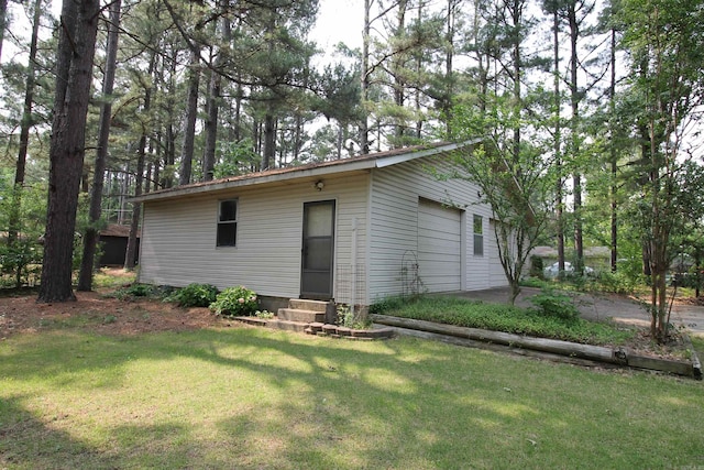 2102 N 22nd St, Paragould, AR 72450 - rear view of property featuring entry steps, a yard, an outdoor structure, and a detached garage