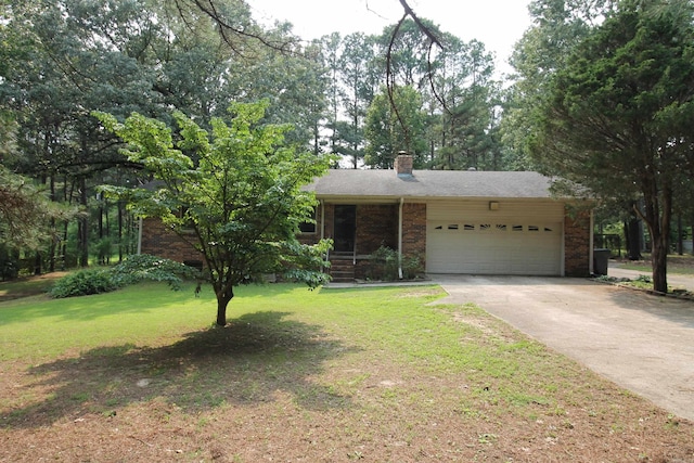 2102 N 22nd St, Paragould, AR 72450 - view of front facade with a garage, a front yard, driveway, a chimney, and brick siding