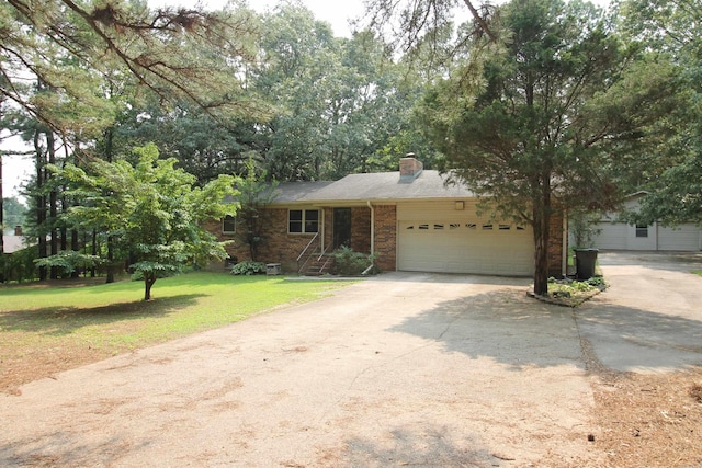 2102 N 22nd St, Paragould, AR 72450 - view of front facade with a garage, concrete driveway, a chimney, a front lawn, and brick siding
