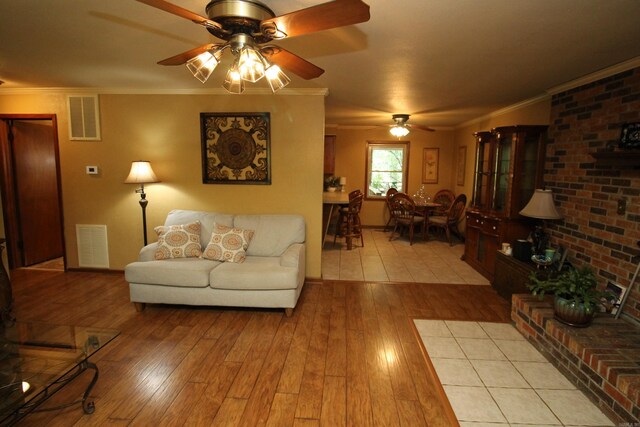2102 N 22nd St, Paragould, AR 72450 - living room featuring a ceiling fan, light wood-type flooring, and ornamental molding