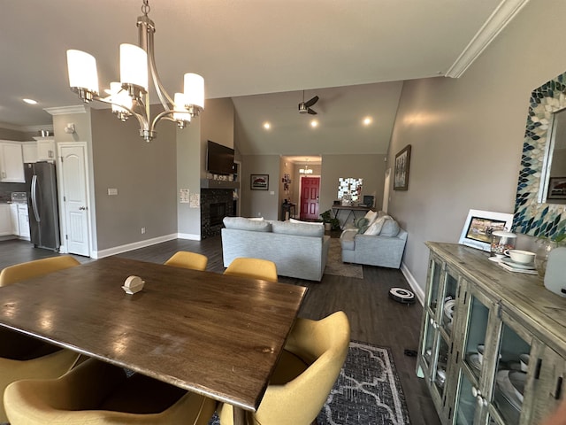 1008 Wildcat Ln, Jonesboro, AR 72405 - dining area with a fireplace, crown molding, dark wood-type flooring, baseboards, and a chandelier